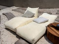 Two empty modern cozy white bean bag beds with pillows decoration on outdoor garden. Royalty Free Stock Photo