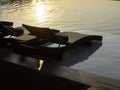 Two empty modern rattan sunbeds, bed chairs for guests on white marble floor. Royalty Free Stock Photo