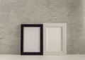 Two empty photo frames on a table or shelf with a copy of the space Royalty Free Stock Photo
