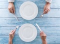 Two empty plates and cutlery in the human hands. Royalty Free Stock Photo