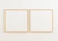 Double 10x10 Square Wood Frame mockup on white wall.