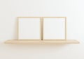 Double 10x10 Square Wood Frame mockup on wooden shelf and white wall