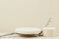 Two empty round beige platform podiums and dry tree twigs on white beach sand background. Minimal creative composition