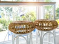 Two empty round rattan bar stool chairs near the table and glass window decoration in cafe. Royalty Free Stock Photo