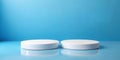 Two empty round white platforms stacked on top of each other, decorated on blue background. Empty space for display product, text Royalty Free Stock Photo