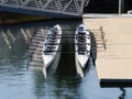 Two Empty Rowing Shells Sitting At Dock Side