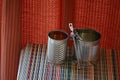 Two empty tin cans with an opener. Royalty Free Stock Photo