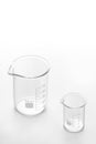 Two glass beakers on a white background