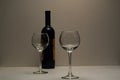 Two empty, transparent glasses and a bottle of good red wine. Royalty Free Stock Photo