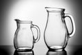 Two empty water jugs against illuminated background Royalty Free Stock Photo