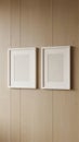 Two empty white frames hanging on a wooden wall Royalty Free Stock Photo
