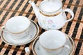 Two empty white porcelain cup and teapot on the table Royalty Free Stock Photo