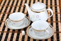 Two empty white porcelain cup and teapot Royalty Free Stock Photo