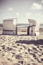 Two empty wicker beach chairs on a beach Royalty Free Stock Photo