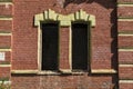 Two empty windows on a red old brick wall Royalty Free Stock Photo