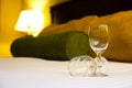 Two empty wine glasses on bed Royalty Free Stock Photo