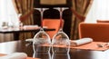 Two Empty Wine Glasses with Decorative Etching Placed Upside Down on a Restaurant Table image Royalty Free Stock Photo