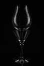 Two empty wine glasses placed in front of each other on a black background. Close up. Text space Royalty Free Stock Photo