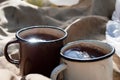 Two enameled cups of tea. Old hiking gear