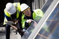 Two  Engineer Discussing and Checking Solar Panels Royalty Free Stock Photo