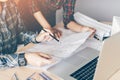 Two engineering man or co-workers working on a project and discussing together with looking at blueprint paperwork. Royalty Free Stock Photo