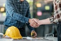 Two engineering man with construction worker greeting a foreman at renovating apartment. Royalty Free Stock Photo