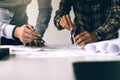 Two engineering man working with blueprints and discussing project together at the meeting in the office. Royalty Free Stock Photo