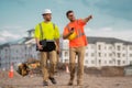 Two engineers. Architect at a construction site. Handyman builders in hardhat. Building concept. Builder foreman. Two Royalty Free Stock Photo