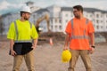 Two engineers. Architect at a construction site. Handyman builders in hardhat. Building concept. Builder foreman. Two Royalty Free Stock Photo