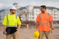 Two engineers. Architect at a construction site. Handyman builders in hardhat. Building concept. Builder foreman. Two Royalty Free Stock Photo