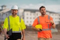 Two engineers. Architect at a construction site. Handyman builders in hardhat. Building concept. Builder foreman. Two Royalty Free Stock Photo