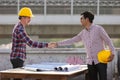 Two engineers shaking hands Royalty Free Stock Photo