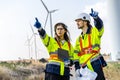 Two engineers caucasian man and woman in hardhat and goggles talk about system installation and walking to verify that a wind