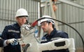 The two engineers check the operation of welding robots