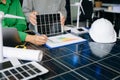 Two engineers collaborate on solar and wind energy, driving clean innovation and sustainability. A vision of teamwork
