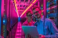 Two IT Engineers in Data Center Works on Laptop Computer Royalty Free Stock Photo