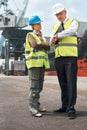 Time is of the essence.. Two engineers discussing planning on a site while in the shipyard.