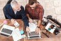 Two engineers are engaged in designing models for a 3d printer. They work on their laptops in the abortion.