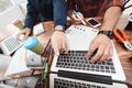 Two engineers are engaged in designing models for a 3d printer. They work on their laptops in the abortion.