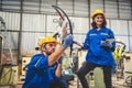 Two engineers mechanic using computer controller Robotic arm for welding steel in steel factory workshop. Industry robot