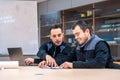 Two engineers talking sitting in a meeting room