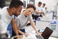 Two Engineers Using CAD Programming Software On Laptop