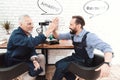 Two engineers work in a modern laboratory with a 3d printer. They have conversational clouds over their heads. Royalty Free Stock Photo