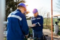 Two engineers working inside oil and gas refinery Royalty Free Stock Photo