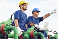 Two engineers working inside oil and gas refinery Royalty Free Stock Photo