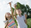 Two enthusiastic kids playing with simple paper planes Royalty Free Stock Photo