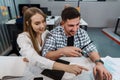 Two entrepreneurs man and woman sitting together working in an office Royalty Free Stock Photo