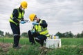 Two Environmental Engineers Inspect Water Quality and Take Water Samples Notes in The Field Near Farmland, Natural Water Sources Royalty Free Stock Photo