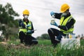 Two Environmental Engineers Inspect Water Quality and Take Water Samples Notes in The Field Near Farmland, Natural Water Sources Royalty Free Stock Photo