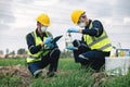 Two Environmental Engineers Inspect Water Quality and Take Water Samples Notes in The Field Near Farmland, Natural Water Sources Royalty Free Stock Photo